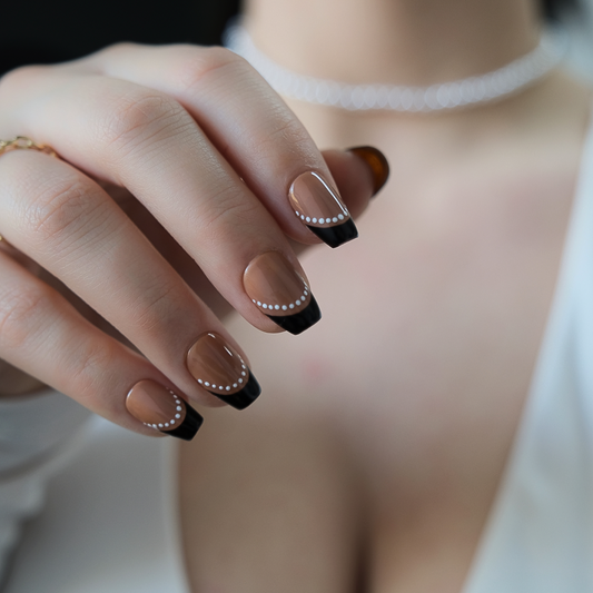 Handmade short brown coffin press-on nails with black French tips and white dotted frame accents. Modern nail art perfect for everyday wear, parties, or gifting.