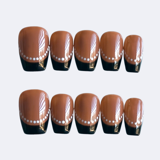 Handmade short brown coffin press-on nails with black French tips and white dotted frame accents. Modern nail art perfect for everyday wear, parties, or gifting.