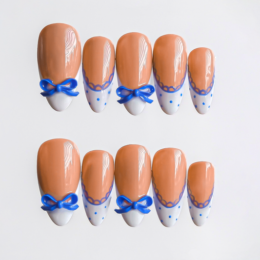 Elegant 3D blue bow press-on nails with white French tips, blue lace and dots, medium almond shape — handmade for weddings and birthdays.